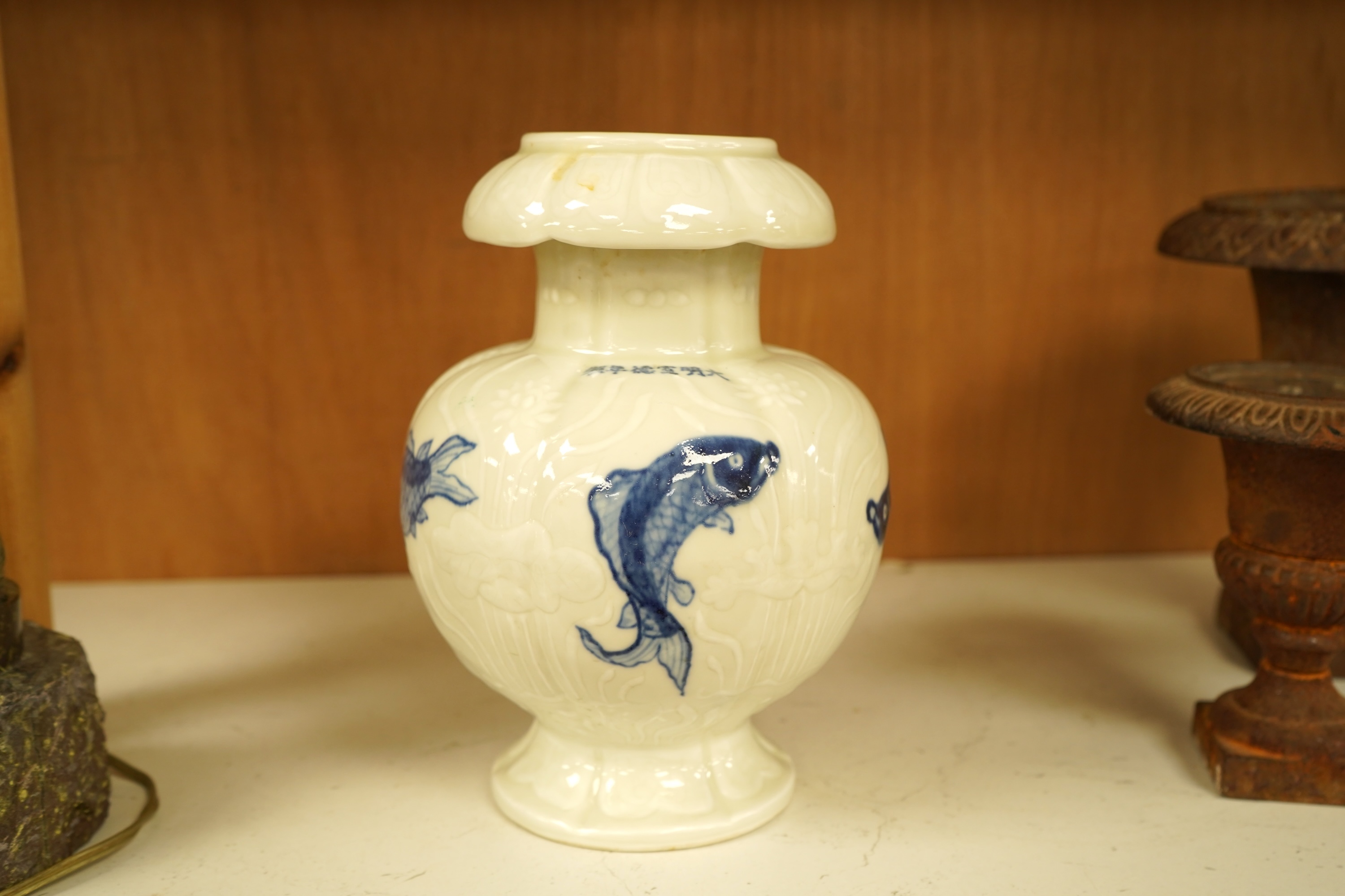 A Chinese vase decorated in low relief, hand painted with fish, 20cm high